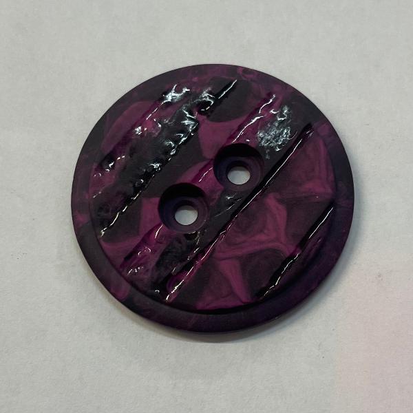 product photo of two-hole button in marbled magenta and black plastic