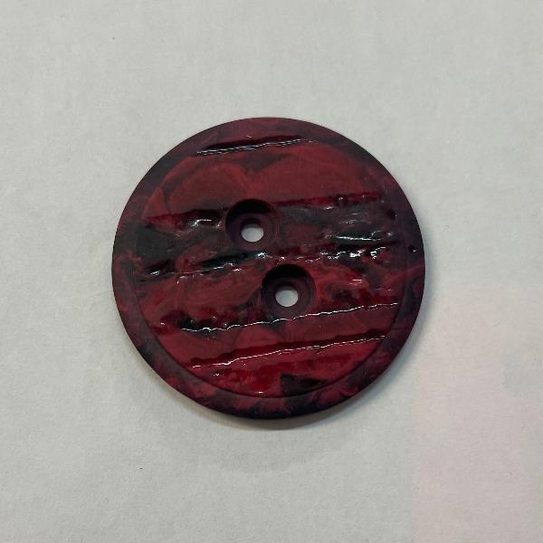 product photo of two-hole button in marbled red and black plastic